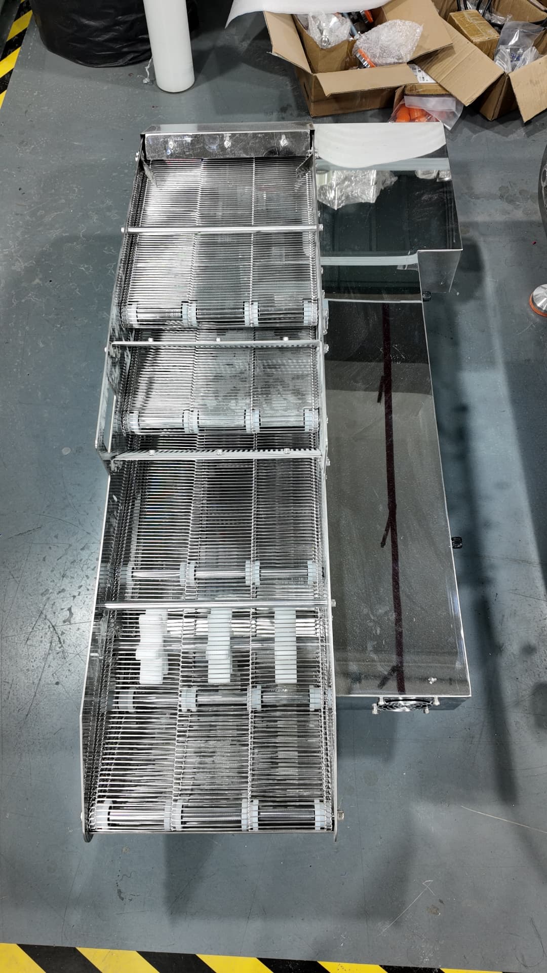 Top view of the stainless mesh conveyor belts inside the coater